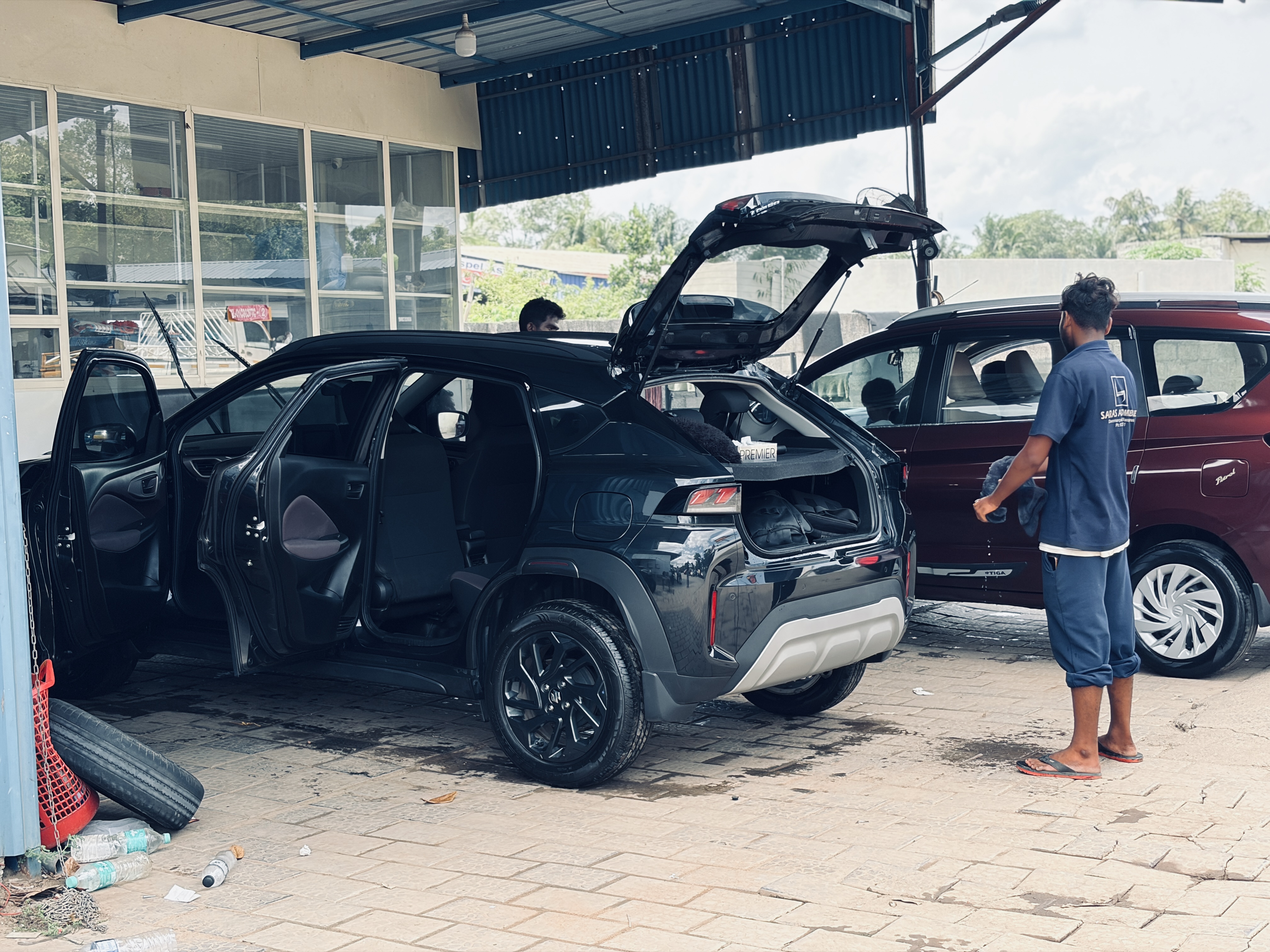 SARAS Automobiles expert technicians working on a vehicle in a modern workshop